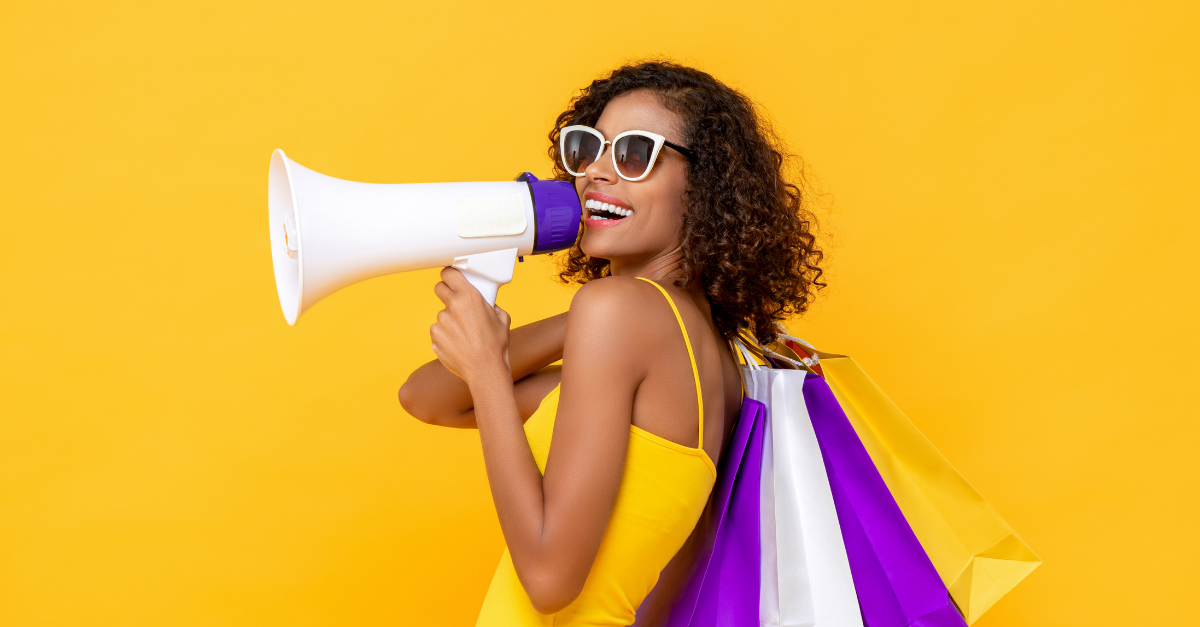 woman holding shopping bags and a microphone in her hand